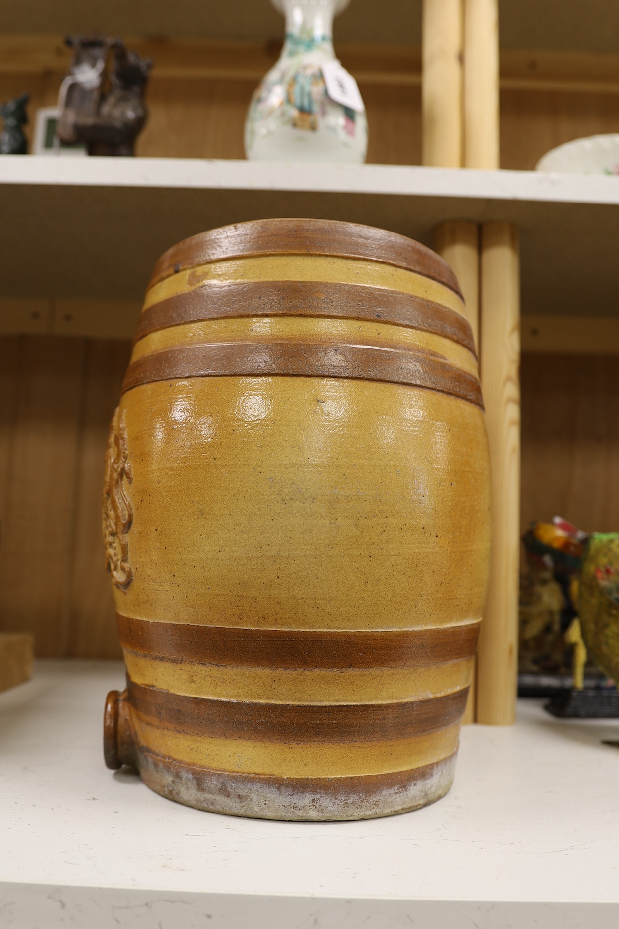 A Doulton and Watts stoneware spirit barrel, applied with the Royal coat of arms, 33.5cm high. Condition - some scratches in the glazing and marks on band by tap aperture